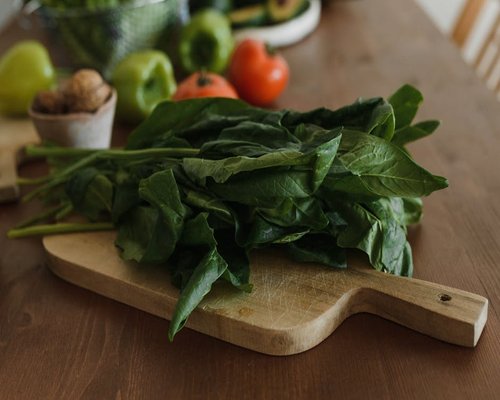 Fresh fruits nuts and green vegetables on a rustic table